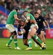 7 October 2023; Pierre Schoeman of Scotland is tackled by Ireland's Caelan Doris, left, and Stuart McCloskey during the 2023 Rugby World Cup Pool B match between Ireland and Scotland at the Stade de France in Paris, France. Photo by Brendan Moran/Sportsfile