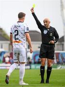 7 October 2023; Bartlomiej Kukulowicz of Bohemians is shown a yellow card by referee Neil Doyle during the Sports Direct Men’s FAI Cup semi-final match between Galway United and Bohemians at Eamonn Deacy Park in Galway. Photo by Stephen McCarthy/Sportsfile