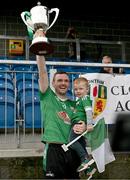 8 October 2023; Erin’s Own Cargin captain James Laverty, with his son Daniel, lifts the cup after the Antrim County Senior Club Football Championship final match between Cuchullians Dunloy and Erin’s Own Cargin at Corrigan Park in Belfast. Photo by Ramsey Cardy/Sportsfile