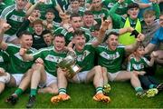 8 October 2023; Mohill captain Shane Quinn, 6, holds the Fenagh Cup as he celebrates with team-mates after their side's victory in the Leitrim County Senior Club Football Championship final match between Mohill and St Mary's Kiltoghert at Avant Money Páirc Seán Mac Diarmada in Carrick-on-Shannon, Leitrim. Photo by Piaras Ó Mídheach/Sportsfile