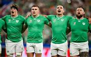 7 October 2023; Ireland players, from left, Josh van der Flier, Garry Ringrose, James Lowe and Andrew Porter stand for the national anthem before the 2023 Rugby World Cup Pool B match between Ireland and Scotland at the Stade de France in Paris, France. Photo by Brendan Moran/Sportsfile