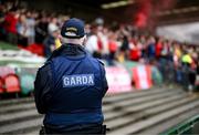 8 October 2023; A member of An Garda Síochána watches in the direction of supporters before the Sports Direct Men’s FAI Cup semi-final match between Cork City and St Patrick's Athletic at Turner’s Cross in Cork. Photo by Stephen McCarthy/Sportsfile