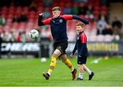 8 October 2023; Chris Forrester of St Patrick's Athletic warms up with Adam McGill, son of St Patrick's Athletic equipment manager David McGill, before the Sports Direct Men’s FAI Cup semi-final match between Cork City and St Patrick's Athletic at Turner’s Cross in Cork. Photo by Stephen McCarthy/Sportsfile