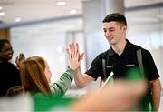 9 October 2023; Rhys McClenaghan of Ireland high fives Isabelle Ledwith, 11, from Batterstown, Meath, on his return at Dublin Airport after winning gold in the Men's Pommel Horse Final at the 2023 World Artistic Gymnastics Championships. Photo by Ramsey Cardy/Sportsfile
