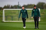 10 October 2023; Evan Ferguson accompanied by Kieran Crowley, FAI communications manager, makes his way to a press conference following a Republic of Ireland training session at the FAI National Training Centre in Abbotstown, Dublin. Photo by Stephen McCarthy/Sportsfile