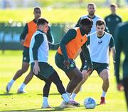 12 October 2023; Festy Ebosele is tackled by Jason Knight, left, and Jayson Molumby, right, during a Republic of Ireland training session at the FAI National Training Centre in Abbotstown, Dublin. Photo by Stephen McCarthy/Sportsfile