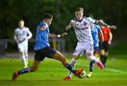 12 October 2023; Danny Grant of Bohemians in action against Evan Osam of UCD during the SSE Airtricity Men's Premier Division match between UCD and Bohemians at UCD Bowl in Dublin. Photo by Ben McShane/Sportsfile