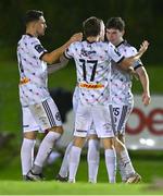 12 October 2023; James Clarke of Bohemians, right, celebrates with teammates including Adam McDonnell, 17, and Krystian Nowak after scoring their side's first goal during the SSE Airtricity Men's Premier Division match between UCD and Bohemians at UCD Bowl in Dublin. Photo by Ben McShane/Sportsfile