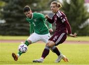 13 October 2023; James Furlong of Republic of Ireland in action against Kristofers Rekis of Latvia during the UEFA European U21 Championship qualifying group A match between Latvia and Republic of Ireland at the Zemgales Olympic Centre in Jelgava, Latvia. Photo by Roman Koksarov/Sportsfile