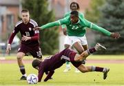 13 October 2023; Aidomo Emakhu of Republic of Ireland in action against Kaspars Anmanis of Latvia during the UEFA European U21 Championship qualifying group A match between Latvia and Republic of Ireland at the Zemgales Olympic Centre in Jelgava, Latvia. Photo by Roman Koksarov/Sportsfile