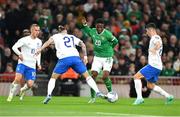 13 October 2023; Chiedozie Ogbene of Republic of Ireland in action against Kostas Tsimikas, left, and Petros Mantalos of Greece during the UEFA EURO 2024 Championship qualifying group B match between Republic of Ireland and Greece at the Aviva Stadium in Dublin. Photo by Seb Daly/Sportsfile