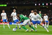 13 October 2023; Chiedozie Ogbene of Republic of Ireland in action against Panagiotis Retsos of Greece during the UEFA EURO 2024 Championship qualifying group B match between Republic of Ireland and Greece at the Aviva Stadium in Dublin. Photo by Stephen McCarthy/Sportsfile