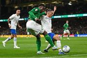 13 October 2023; Chiedozie Ogbene of Republic of Ireland and Kostas Tsimikas of Greece during the UEFA EURO 2024 Championship qualifying group B match between Republic of Ireland and Greece at the Aviva Stadium in Dublin. Photo by Stephen McCarthy/Sportsfile
