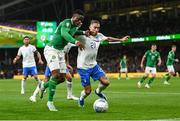 13 October 2023; Chiedozie Ogbene of Republic of Ireland and Kostas Tsimikas of Greece during the UEFA EURO 2024 Championship qualifying group B match between Republic of Ireland and Greece at the Aviva Stadium in Dublin. Photo by Stephen McCarthy/Sportsfile
