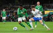 13 October 2023; Chiedozie Ogbene of Republic of Ireland in action against Panagiotis Retsos of Greece during the UEFA EURO 2024 Championship qualifying group B match between Republic of Ireland and Greece at the Aviva Stadium in Dublin. Photo by Seb Daly/Sportsfile