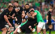 14 October 2023; Shannon Frizell of New Zealand is tackled by Ireland players Tadhg Furlong, hidden, and Jonathan Sexton, right, during the 2023 Rugby World Cup quarter-final match between Ireland and New Zealand at the Stade de France in Paris, France. Photo by Ramsey Cardy/Sportsfile