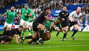 14 October 2023; Bundee Aki of Ireland on his way to scoring his side's first try, in the 27th minute, despite the tackle of New Zealand's Rieko Ioane, during the 2023 Rugby World Cup quarter-final match between Ireland and New Zealand at the Stade de France in Paris, France. Photo by Harry Murphy/Sportsfile