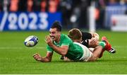 14 October 2023; James Lowe of Ireland off-loads as he is tackled by Jordie Barrett of New Zealand during the 2023 Rugby World Cup quarter-final match between Ireland and New Zealand at the Stade de France in Paris, France. Photo by Harry Murphy/Sportsfile