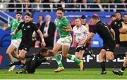 14 October 2023; Hugo Keenan of Ireland evades the tackle of Aaron Smith and Sam Cane of New Zealand during the 2023 Rugby World Cup quarter-final match between Ireland and New Zealand at the Stade de France in Paris, France. Photo by Harry Murphy/Sportsfile