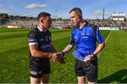 15 October 2023; Referee Brian Higgins with Kilcoo captain Darryl Branagan before the Down County Senior Club Football Championship final match between Burren and Kilcoo at Pairc Esler in Newry, Down. Photo by Ben McShane/Sportsfile