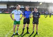 15 October 2023; Referee Brian Higgins with team captains Gerard McGovern of Burren, left, and Darryl Branagan of Kilcoo before the Down County Senior Club Football Championship final match between Burren and Kilcoo at Pairc Esler in Newry, Down. Photo by Ben McShane/Sportsfile