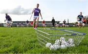 15 October 2023; A shopping basket containing sliotars sits on the pitch at Birr Rugby Club as Shinrone players warm-up before the Offaly County Senior Club Hurling Championship final match between Kilcormac-Killoughey and Shinrone at Grant Heating St Brendan's Park in Birr, Offaly. Photo by Seb Daly/Sportsfile