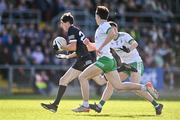 15 October 2023; Eugene Branagan of Kilcoo in action against Ryan Cunningham, centre, and Ardan McAvoy of Burren during the Down County Senior Club Football Championship final match between Burren and Kilcoo at Pairc Esler in Newry, Down. Photo by Ben McShane/Sportsfile
