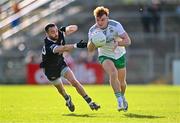 15 October 2023; Danny Magill of Burren evades the tackle of Conor Laverty of Kilcoo during the Down County Senior Club Football Championship final match between Burren and Kilcoo at Pairc Esler in Newry, Down. Photo by Ben McShane/Sportsfile