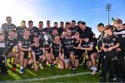 15 October 2023; Kilcoo players celebrate with the cup after the Down County Senior Club Football Championship final match between Burren and Kilcoo at Pairc Esler in Newry, Down. Photo by Ben McShane/Sportsfile