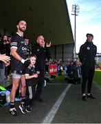 15 October 2023; Conor Laverty of Kilcoo with his son Fiachra during the Down County Senior Club Football Championship final match between Burren and Kilcoo at Pairc Esler in Newry, Down. Photo by Ben McShane/Sportsfile