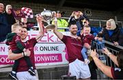 15 October 2023; Ryan McCambridge, left, with his son Conn, age 2, and Neil McManus of Ruairí Óg Cushendall with his daughter Aoibhín, age 1, lift the cup after the Antrim County Senior Club Hurling Championship final match between Ruairi Og Cushendall and Loughgiel Shamrocks at Corrigan Park in Belfast. Photo by David Fitzgerald/Sportsfile