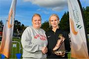 15 October 2023; Noeleen Scanlon of Letterkenny AC, Donegal, right, is presented with the Jim McNamara trophy by Andrea McNamara after winning the master women's 6000m during the Autumn Open International Cross Country Festival & The Athletics Ireland Cross County Xperience at Abbotstown in Dublin. Photo by Sam Barnes/Sportsfile