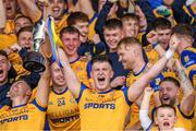 15 October 2023; St Joseph's captain Brian Daly lifts the cup as his team-mates celebrate after the Laois County Senior Club Football Championship final match between St Joseph's and Portlaoise at Laois Hire O'Moore Park in Portlaoise, Laois. Photo by Matt Browne/Sportsfile