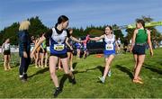 15 October 2023; Erin Finn of Ratoath AC, Meath, takes the baton from team-mate Lily Flood whilst competing in the U15 girls 4x1000m relay during the Autumn Open International Cross Country Festival & The Athletics Ireland Cross County Xperience at Abbotstown in Dublin. Photo by Sam Barnes/Sportsfile