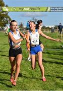 15 October 2023; Isabelle Kane of Dunboyne AC, Meath, takes the baton from team-mate Grace Connell whilst competing in the U15 girls 4x1000m relay during the Autumn Open International Cross Country Festival & The Athletics Ireland Cross County Xperience at Abbotstown in Dublin. Photo by Sam Barnes/Sportsfile