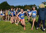 15 October 2023; Saoirse Fitzgerald of Waterford AC, takes the baton from team-mate Lucy Clinton whilst competing in the U15 girls 4x1000m relay during the Autumn Open International Cross Country Festival & The Athletics Ireland Cross County Xperience at Abbotstown in Dublin. Photo by Sam Barnes/Sportsfile