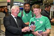 16 October 2023; Bundee Aki of Ireland has a selfie taken with supporters on the Ireland rugby team's return at Dublin Airport from the 2023 Rugby World Cup in Paris, France. Photo by Piaras Ó Mídheach/Sportsfile
