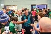 16 October 2023; Captain Jonathan Sexton poses for a selfie with a supporter on the Ireland rugby teams arrival at Dublin Airport from the 2023 Rugby World Cup in France. Photo by Piaras Ó Mídheach/Sportsfile