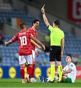16 October 2023; Louie Annesley of Gibraltar recieves a yellow card from referee Christian-Petru Ciochirca during the UEFA EURO 2024 Championship qualifying group B match between Gibraltar and Republic of Ireland at Estádio Algarve in Faro, Portugal. Photo by Stephen McCarthy/Sportsfile