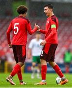 17 October 2023; Eman Kospo of Switzerland, right, and team-mate Marvin Akahomen after the UEFA European U17 Championship qualifying group 10 match between Switzerland and Republic of Ireland at Turner's Cross in Cork. Photo by Eóin Noonan/Sportsfile