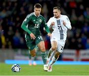 17 October 2023; Brad Lyons of Northern Ireland in action against Timi Elšnik of Slovenia during the UEFA EURO 2024 Championship qualifying group H match between Northern Ireland and Slovenia at the National Football Stadium at Windsor Park in Belfast. Photo by Ramsey Cardy/Sportsfile