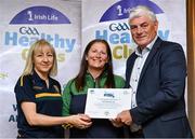 20 October 2023; The GAA is thrilled to announce and honor GAA clubs with the official &quot;Healthy Club&quot; designation. In recent years, Leinster clubs have actively taken part in the GAA's prominent Healthy Clubs pilot program, generously supported by Irish Life. Pictured are Eileen Dunne and Maeve Conroy of the Park Ratheniska club in Laois being presented with their foundation award by Leinster Council health and wellbeing chairperson Dave Murray at the Killeshin Hotel in Portlaoise, Laois. Photo by Brendan Moran/Sportsfile