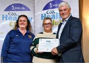 20 October 2023; The GAA is thrilled to announce and honor GAA clubs with the official &quot;Healthy Club&quot; designation. In recent years, Leinster clubs have actively taken part in the GAA's prominent Healthy Clubs pilot program, generously supported by Irish Life. Pictured are Cora Moran and Marian O'Neill of the St Colmcilles GFC club in Swords, Dublin being presented with their foundation award by Leinster Council health and wellbeing chairperson Dave Murray at the Killeshin Hotel in Portlaoise, Laois. Photo by Brendan Moran/Sportsfile