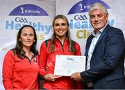20 October 2023; The GAA is thrilled to announce and honor GAA clubs with the official &quot;Healthy Club&quot; designation. In recent years, Leinster clubs have actively taken part in the GAA's prominent Healthy Clubs pilot program, generously supported by Irish Life. Pictured are Susan Donoghue and Paula Hicks of the Glen Emmets club in Louth being presented with their silver award by Leinster Council health and wellbeing chairperson Dave Murray at the Killeshin Hotel in Portlaoise, Laois. Photo by Brendan Moran/Sportsfile