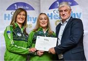 20 October 2023; The GAA is thrilled to announce and honor GAA clubs with the official &quot;Healthy Club&quot; designation. In recent years, Leinster clubs have actively taken part in the GAA's prominent Healthy Clubs pilot program, generously supported by Irish Life. Pictured are Margaret Synnott and Nicola Fitzsimons of the Newtown GAA club in Wicklow being presented with their gold award by Leinster Council health and wellbeing chairperson Dave Murray at the Killeshin Hotel in Portlaoise, Laois. Photo by Brendan Moran/Sportsfile