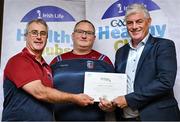 20 October 2023; The GAA is thrilled to announce and honor GAA clubs with the official &quot;Healthy Club&quot; designation. In recent years, Leinster clubs have actively taken part in the GAA's prominent Healthy Clubs pilot program, generously supported by Irish Life. Pictured are Nathan Clements and Mark Dempsey of the Shilleagh Coolboy club in Wicklow being presented with their gold award by Leinster Council health and wellbeing chairperson Dave Murray at the Killeshin Hotel in Portlaoise, Laois. Photo by Brendan Moran/Sportsfile