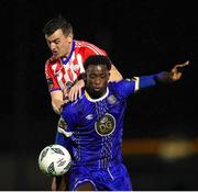 20 October 2023; Roland Idowu of Waterford in action against Marc Ludden of Treaty United during the SSE Airtricity Men's First Division match between Waterford and Treaty United at RSC in Waterford. Photo by Michael P Ryan/Sportsfile