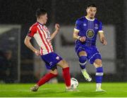 20 October 2023; Colin Conroy of Treaty United in action against Ronan Coughlan of Waterford during the SSE Airtricity Men's First Division match between Waterford and Treaty United at RSC in Waterford. Photo by Michael P Ryan/Sportsfile