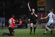 20 October 2023; Referee Rob Hennessy shows a red card to Sadou Diallo of Derry City during the SSE Airtricity Men's Premier Division match between Derry City and Shelbourne at The Ryan McBride Brandywell Stadium in Derry. Photo by Ramsey Cardy/Sportsfile
