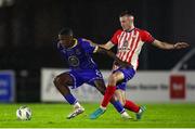 20 October 2023; Romeo Akachukwu of Waterford in action against Lee Devitt of Treaty United during the SSE Airtricity Men's First Division match between Waterford and Treaty United at RSC in Waterford. Photo by Michael P Ryan/Sportsfile